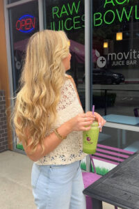 Social media influencer holding smoothie